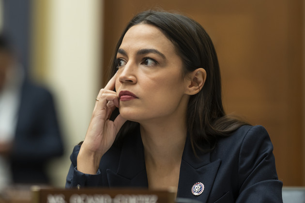 Alexandria Ocasio-Cortez listens as John J. Ray III, CEO of FTX Group, testifies during the House Financial Services Committee hearing.