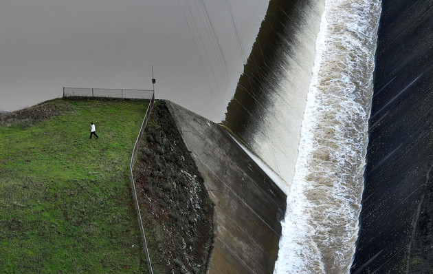 In an aerial view, a man walks by the spillway at Nicasio Reservoir.
