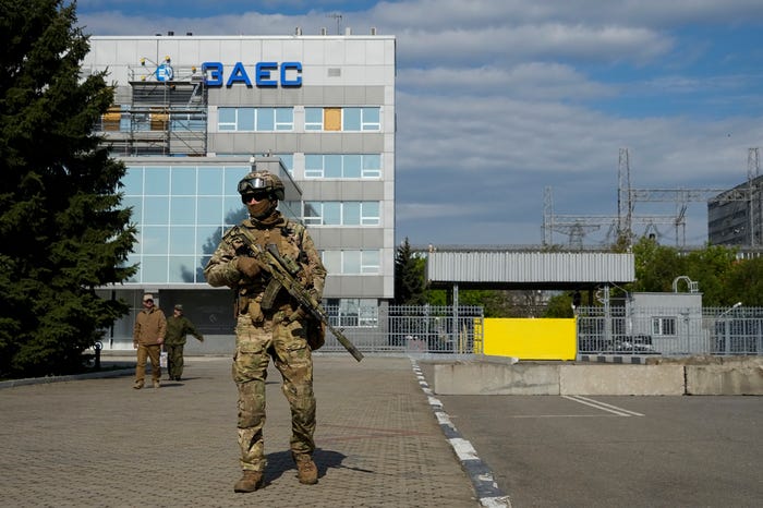 A Russian serviceman stands guard in an area of the Zaporizhzhia Nuclear Power Station in territory under Russian military control, southeastern Ukraine, on May 1, 2022.