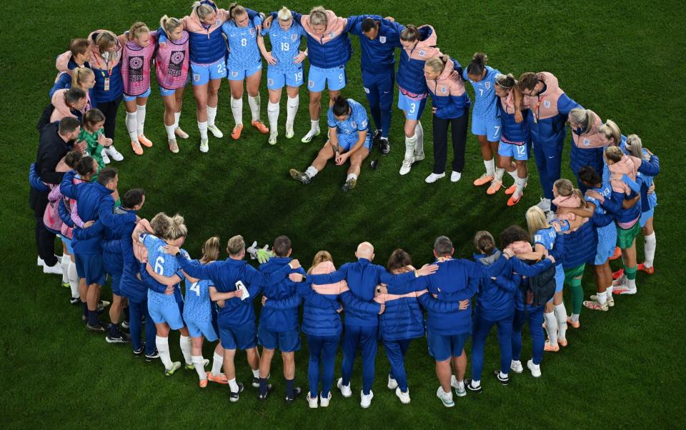 Sarina Wiegman tries to console her players after the defeat