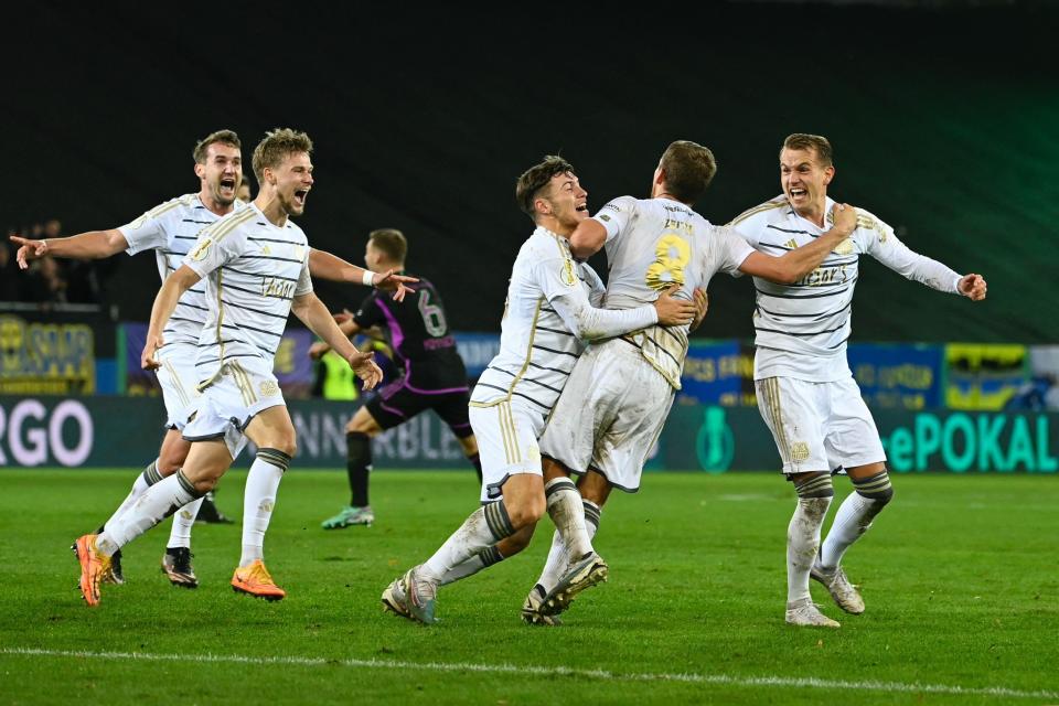 Saarbrücken's players celebrate after their upset victory. (Jean-Christophe Verhaegen/AFP via Getty Images)