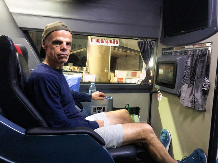 Author Brendan Sainsbury sitting in luxury bus in Thailand