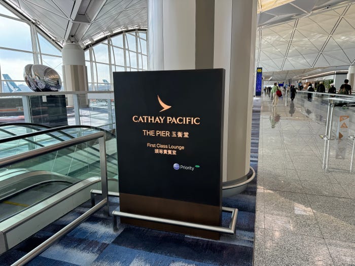 A sign marking the entrance of a first-class airport lounge in Terminal 1 at Hong Kong International Airport. The sigh reads: Cathay Pacific, The Pier.