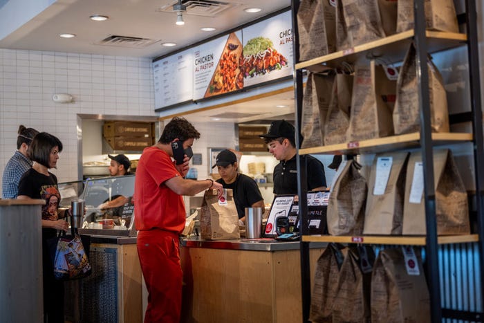 A customer orders food in a Chipotle in Austin, Texas in April 2023