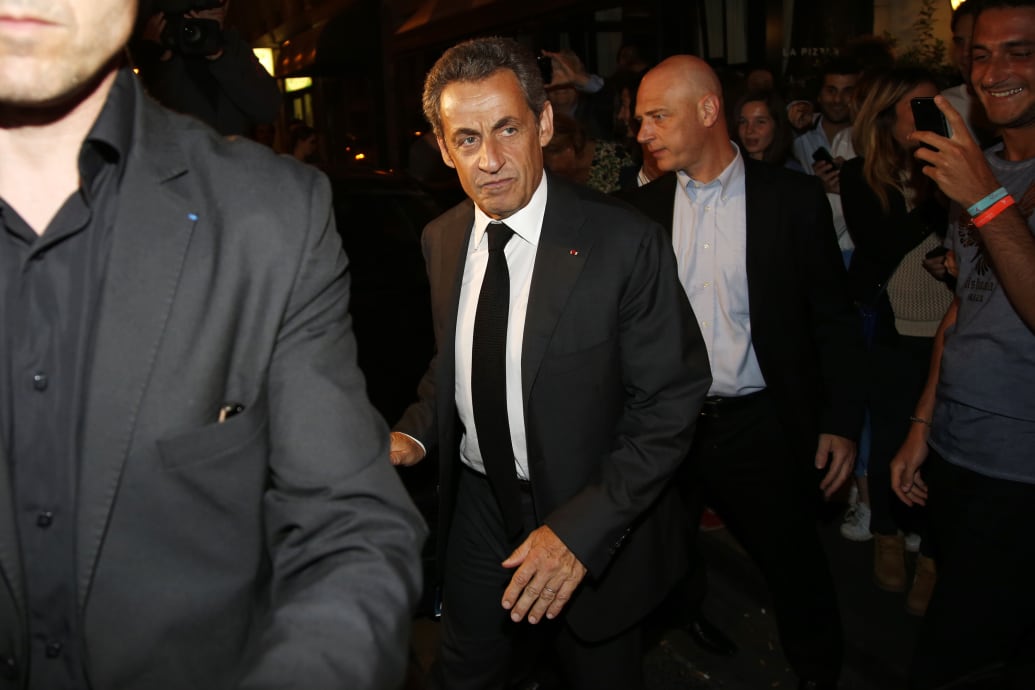 Nicolas Sarkozy exits a vehicle in Paris, France.