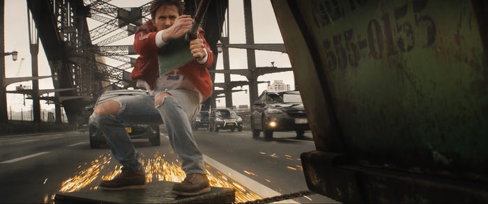 Ryan Gosling holding onto the back of a truck