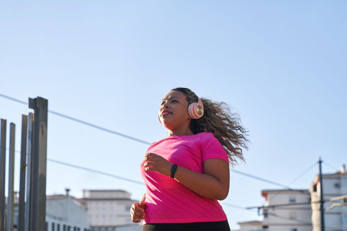 Woman in a pink t-shirt on a run.