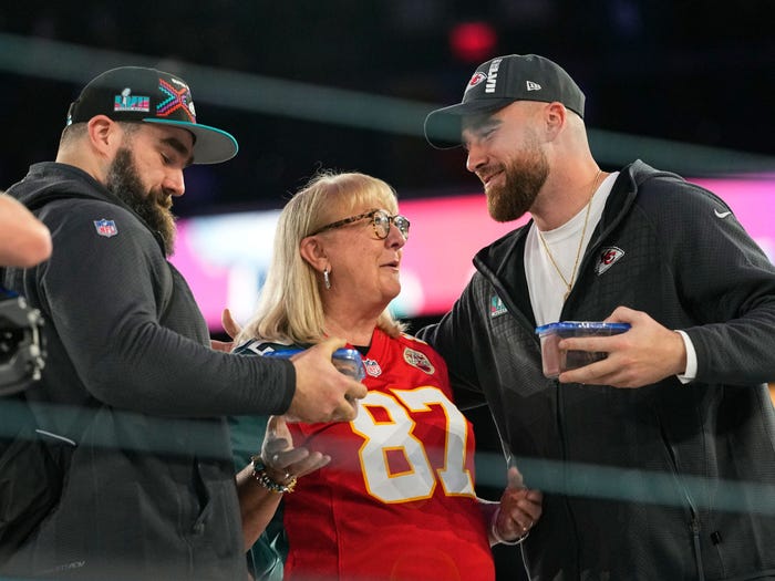 Donna Kelce greets her sons, Philadelphia Eagles center Jason Kelce, left, and Kansas City Chiefs tight end Travis Kelce during the NFL football Super Bowl 57 opening night.