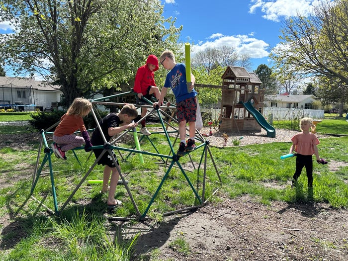 Kids playing on a jungle gym structure in Amber Adrian's neighborhood.