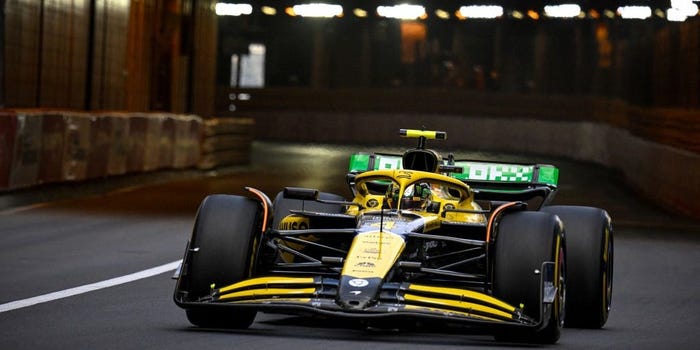 Lando Norris drives the new yellow McLaren Senna livery F1 car out of the Monaco tunnel
