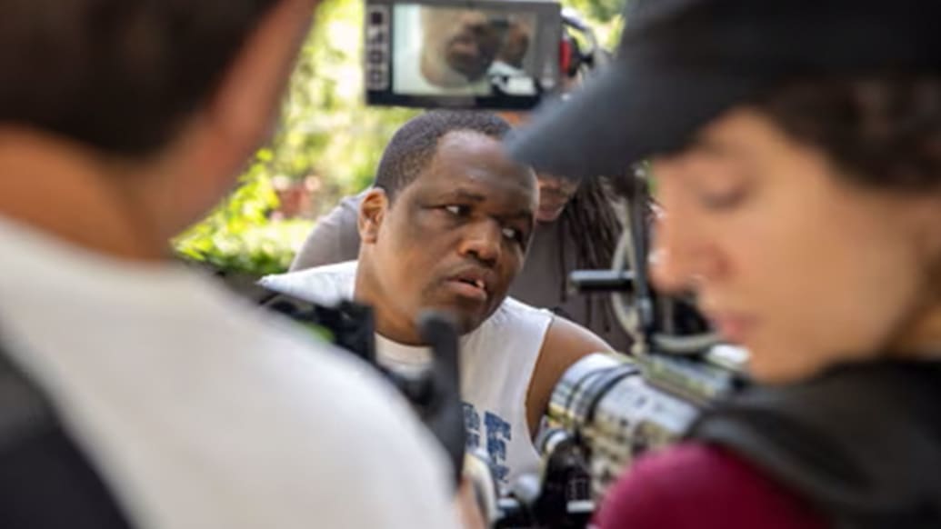 Derrick Johnson is seen through camera men in a still from ‘Tell Them You Love Me’