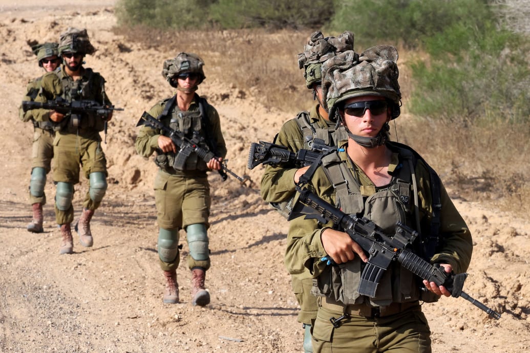 Israeli soldiers hold guns