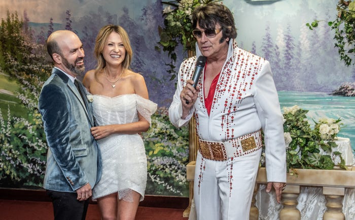 Bride and groom posing with Elvis at Las Vegas chapel
