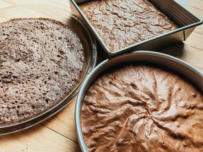thre trays of baked brownies on a counter