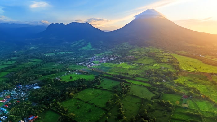 A landscape showing Costa Rica's Arenal volcano and the valley below it