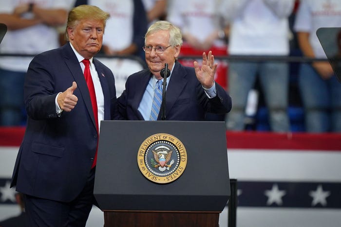 Donald Trump greets Mitch McConnell at a 2019 rally