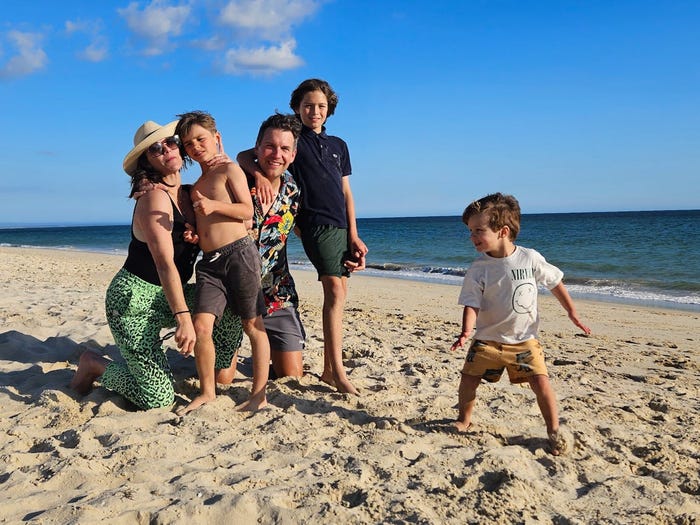 A family of five on a beach