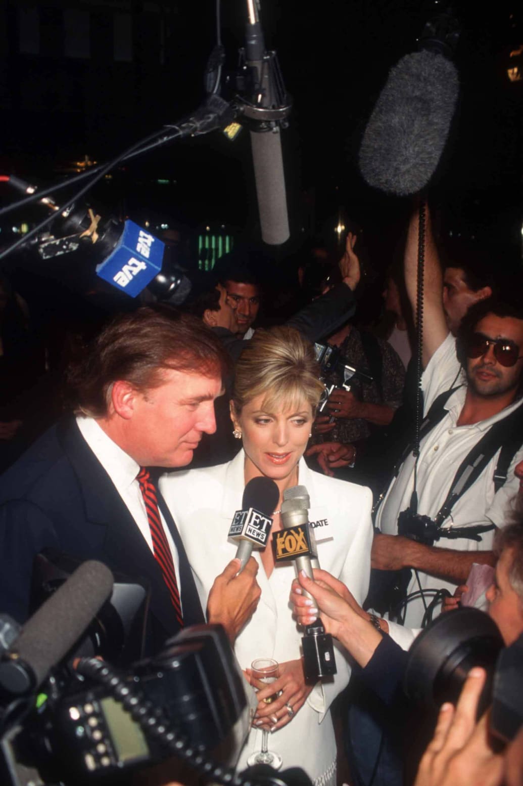 Donald Trump talks to reporters at his 50th birthday celebration in 1996.